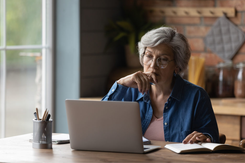 A woman sitting at a table with a laptop