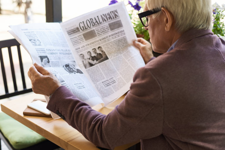 A man reading a newspaper.