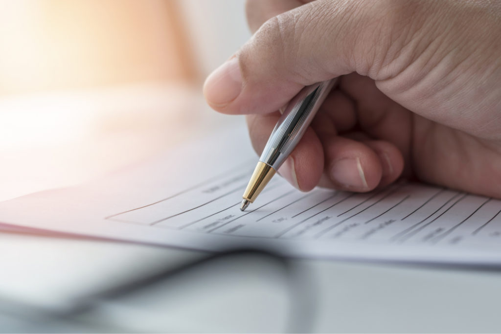 A person filling in paperwork.