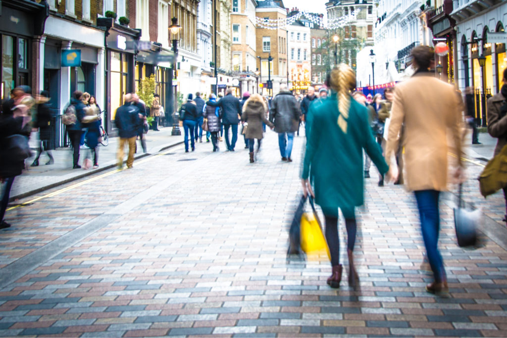 Shoppers walking down a high street.