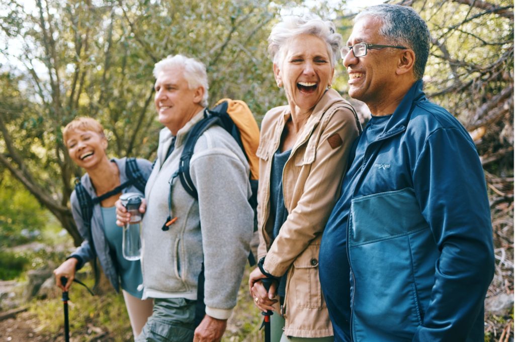 A group of friends hiking and laughing together.