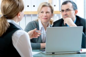 A couple talking to a financial planner.