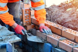 A bricklayer working on a construction site.