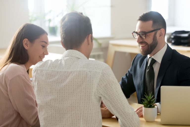 A young couple meeting with a financial planner.