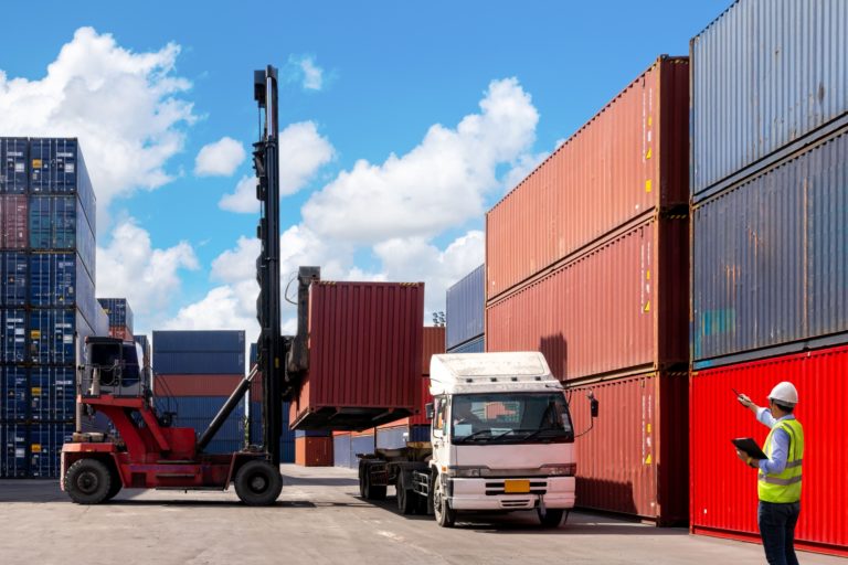 A foreman organising containers from a cargo ship.