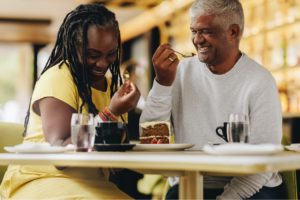A couple laughing together at a café.